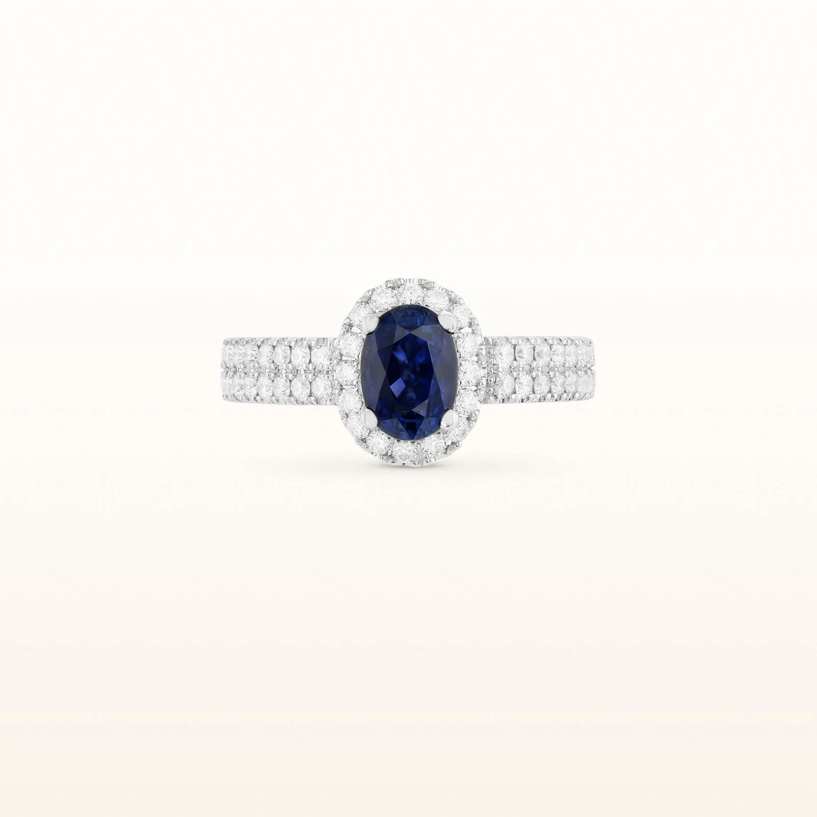 Oval Blue Sapphire and Diamond Halo Ring in 18kt White Gold